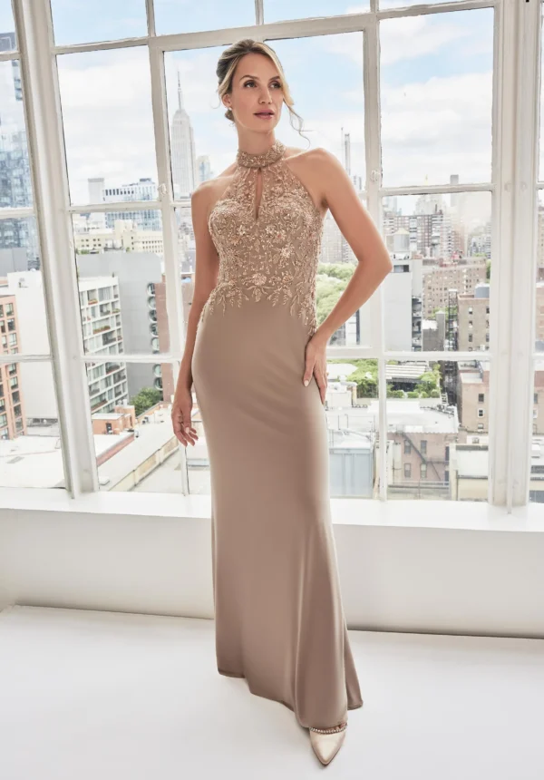 Elegant beige evening gown with sheer keyhole halter neckline and floral beaded bodice.
