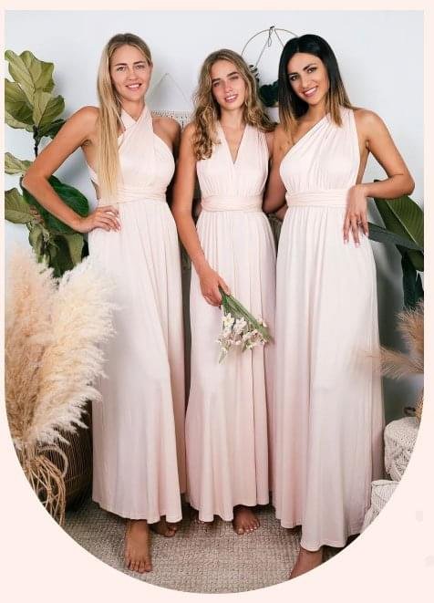 womens in elegant long bridal dresses standing closely together, showcasing their wedding attire.